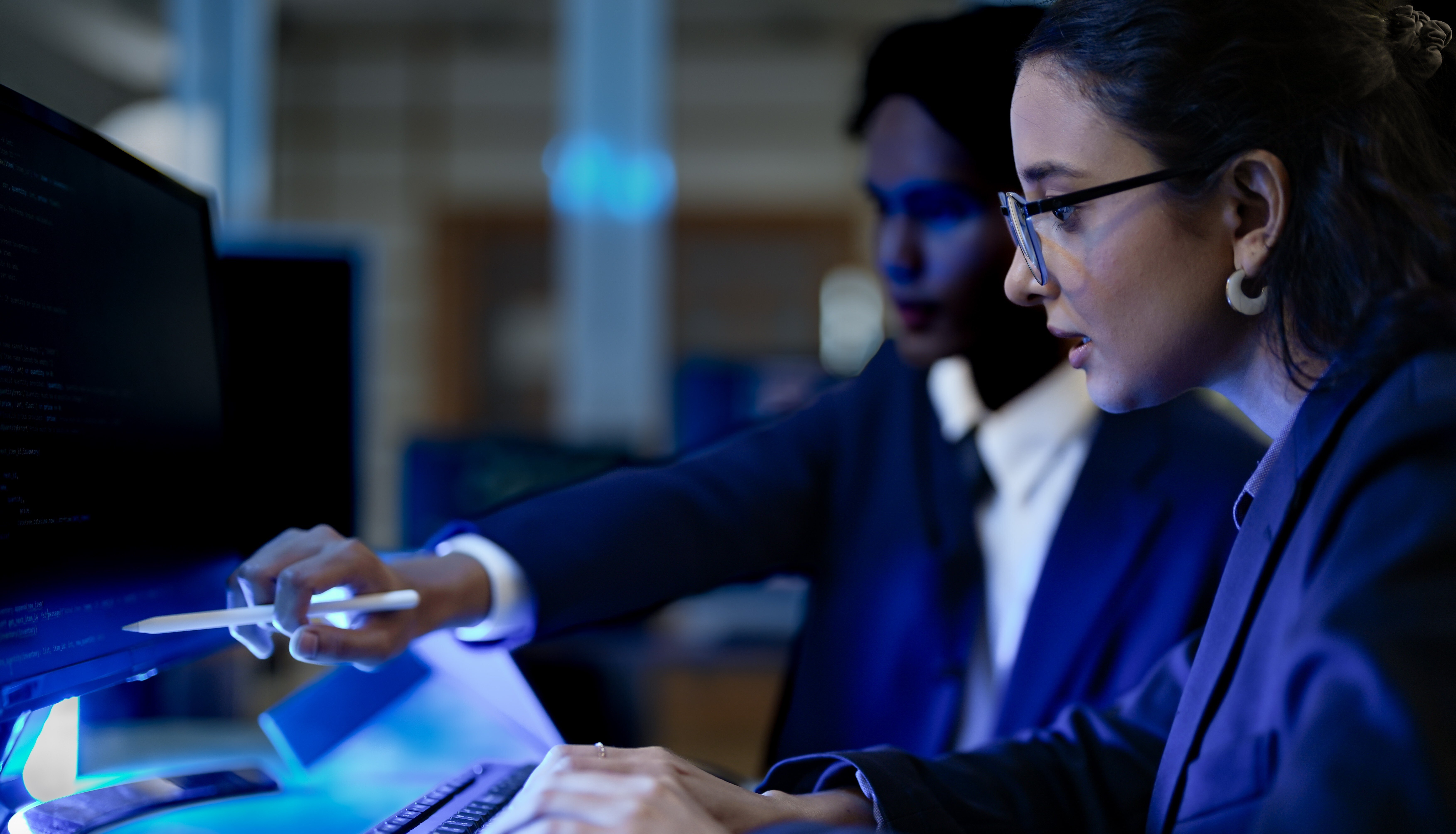 Two cyber security analysts assessing vulnerabilities